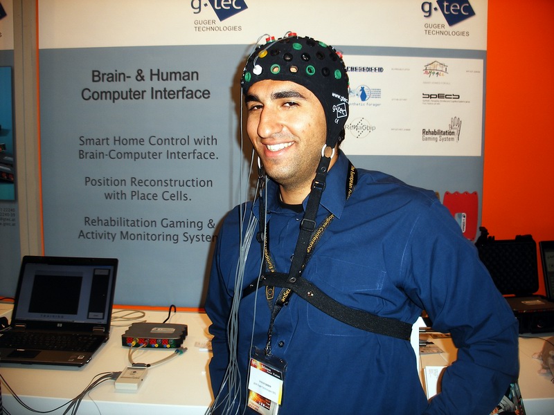 A man wearing an electrode cap for a brain-computer interface demonstration