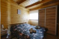 A cozy wooden bedroom with soft floral bedding