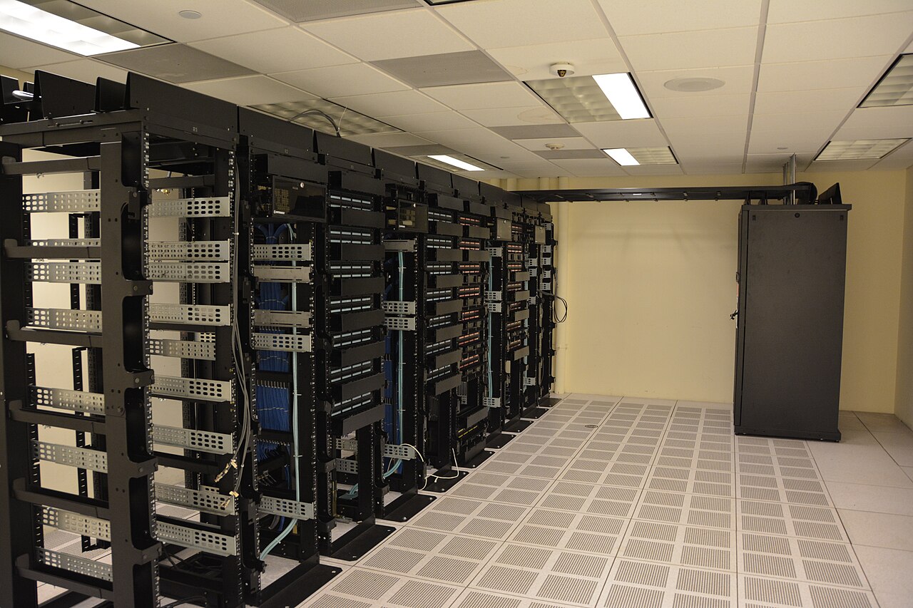 Rows of server racks inside a data center room