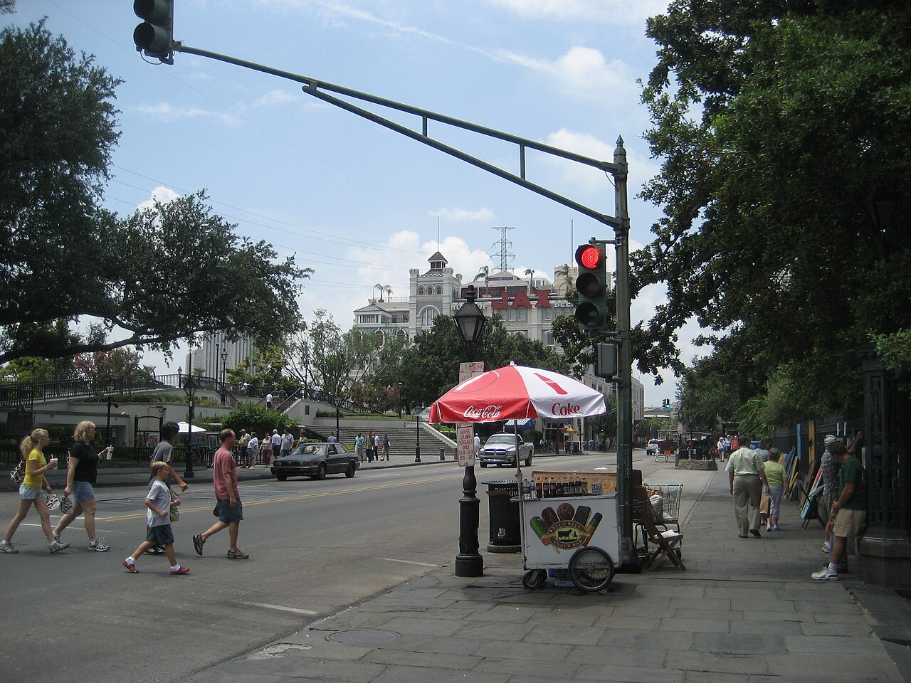 An independent ice cream cart vendor parked on a city street corner