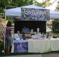 An independent representative selling products at a branded outdoor booth