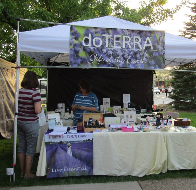 An independent representative selling products at a branded outdoor booth