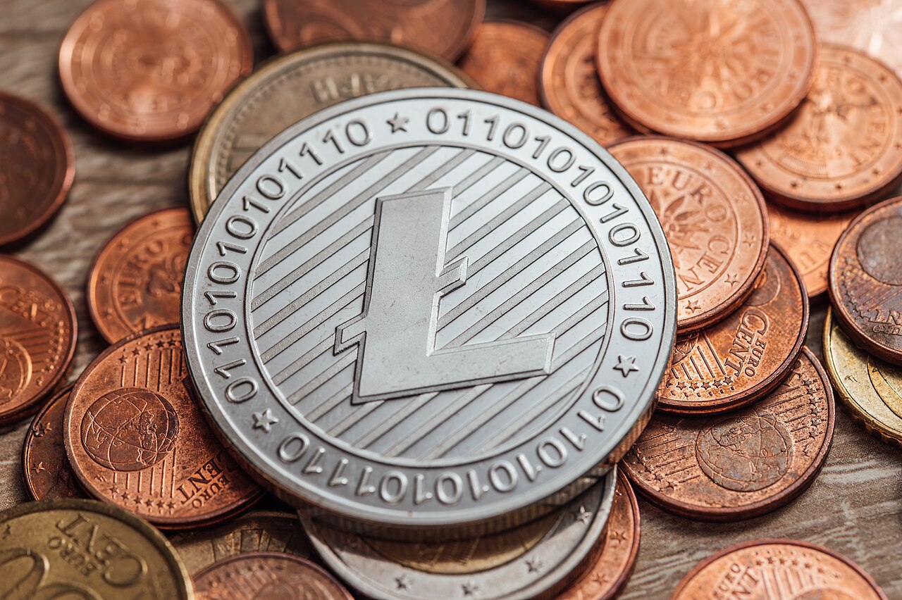 A silver Litecoin cryptocurrency coin resting among euro cent coins