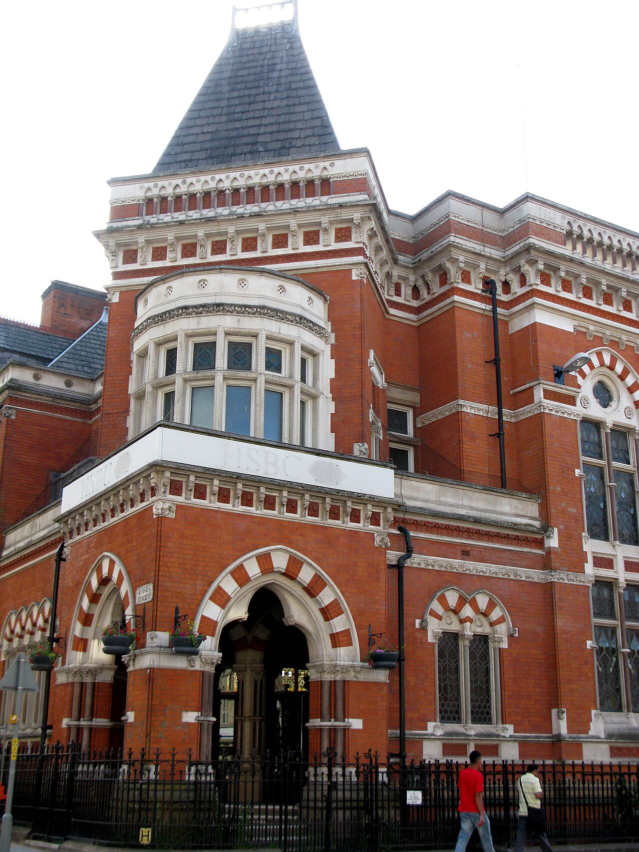 The ornate brick exterior of a traditional HSBC bank building