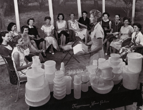 A vintage photo of a Tupperware home party demonstration with a group of women